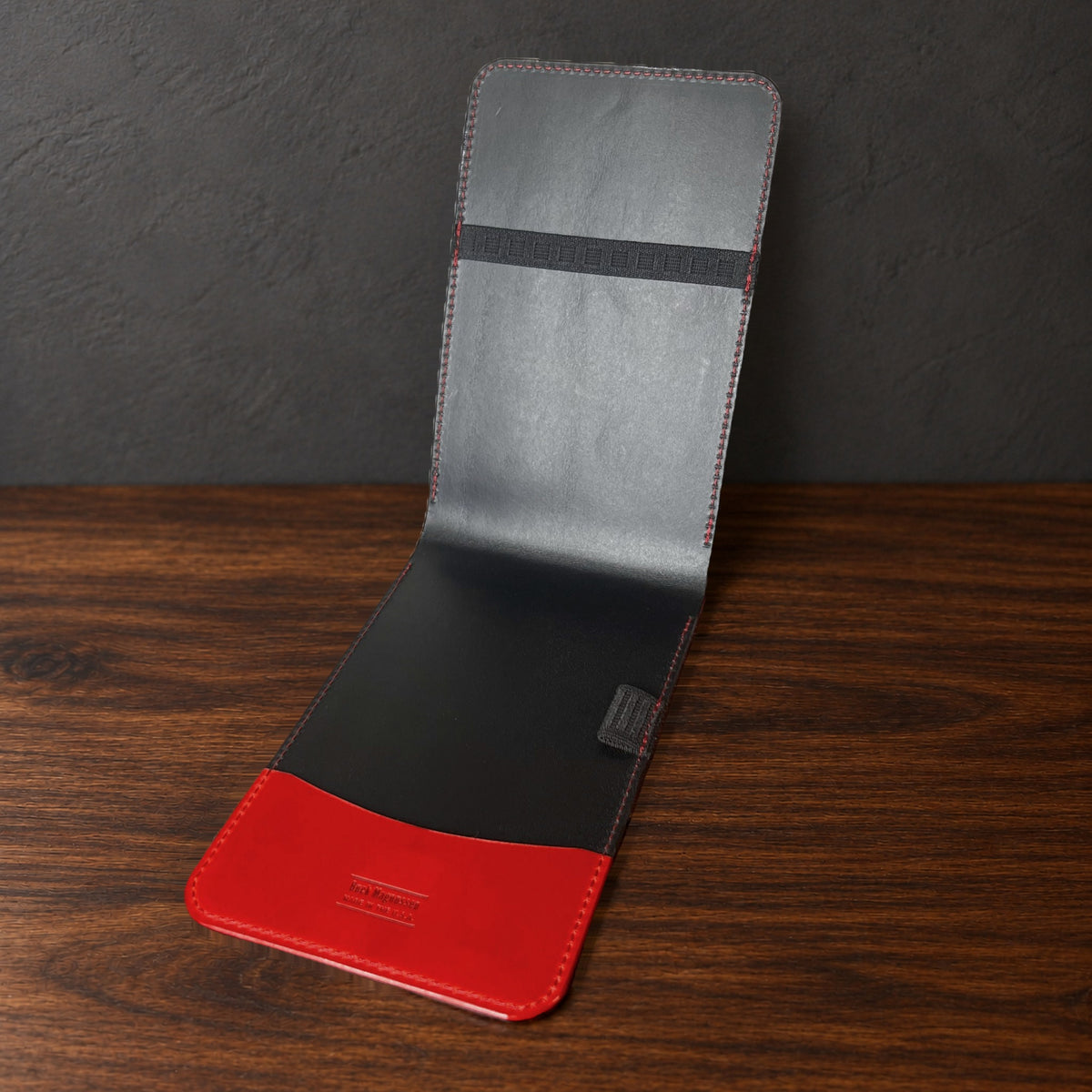 Augusta Classic yardage book cover in Red Buttero standing open, showing the black interior