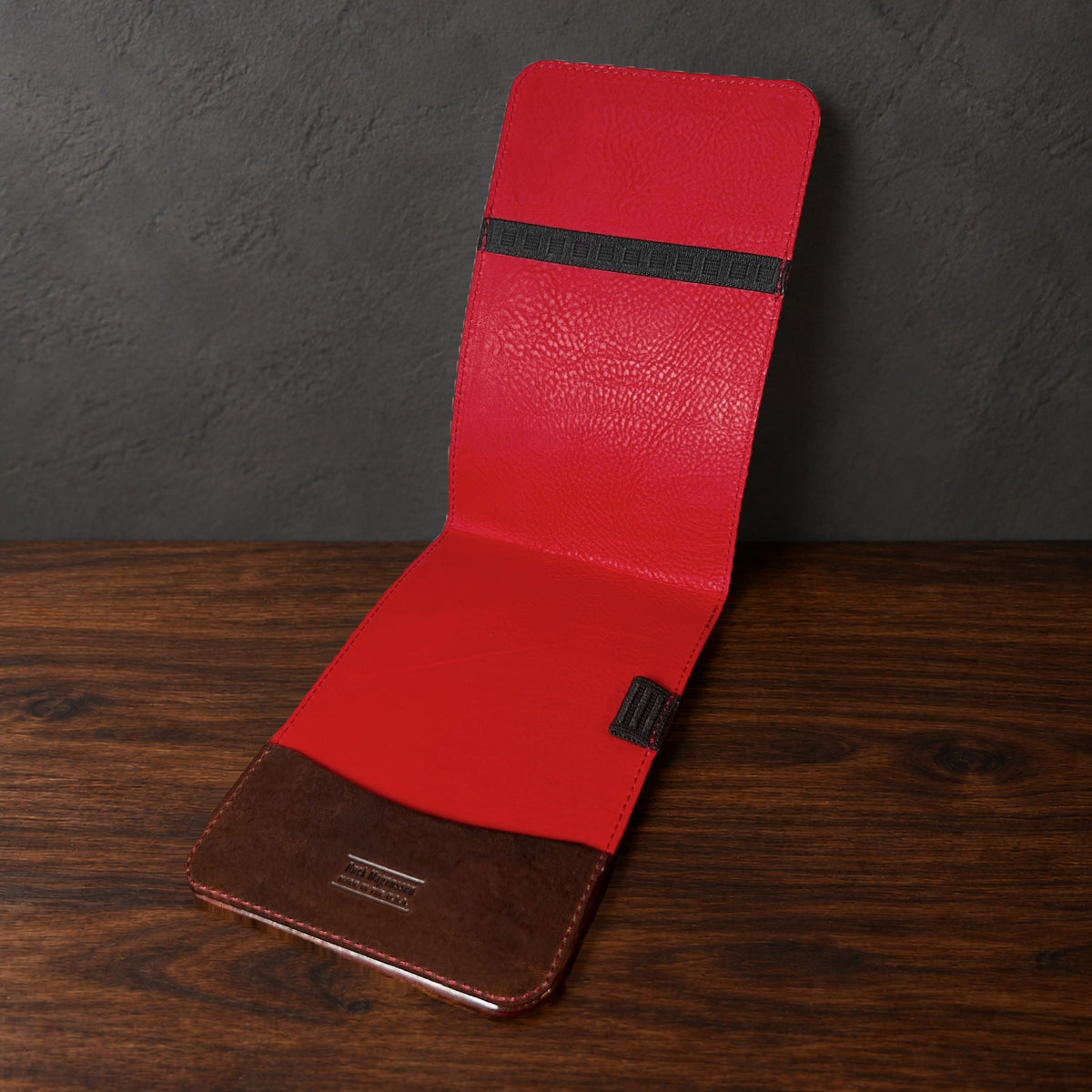 Augusta Classic yardage book cover in Nemesis standing open, showing the red interior