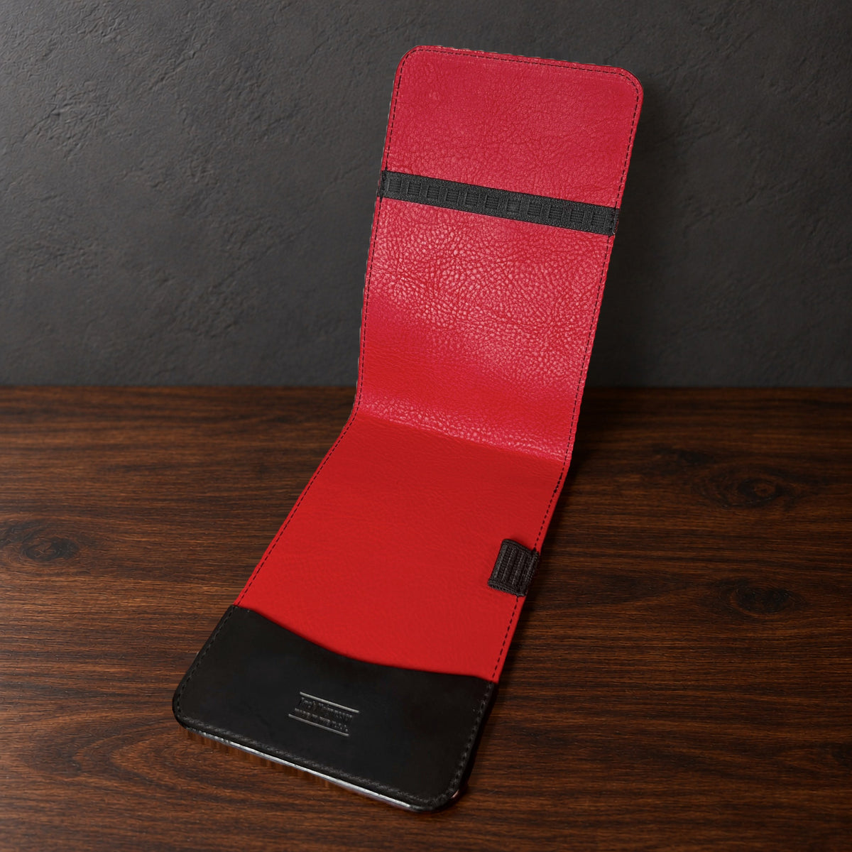 Augusta Classic yardage book cover in Black Waxy standing open, showing the red interior