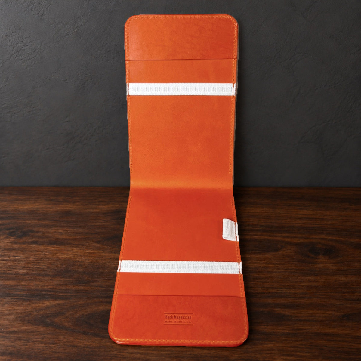 Inside the Oakmont Classic yardage book cover: orange interior, elastics at the top and bottom and a pencil loop