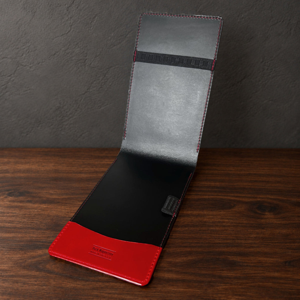 Augusta Pro yardage book cover in Red Buttero standing open, showing the black interior