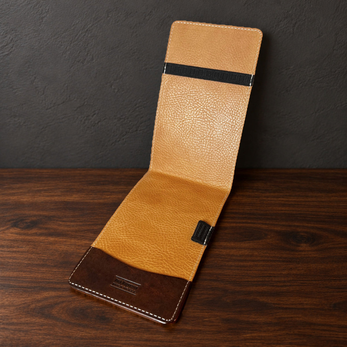 Augusta Pro yardage book cover in Nemesis standing open, showing the natural interior
