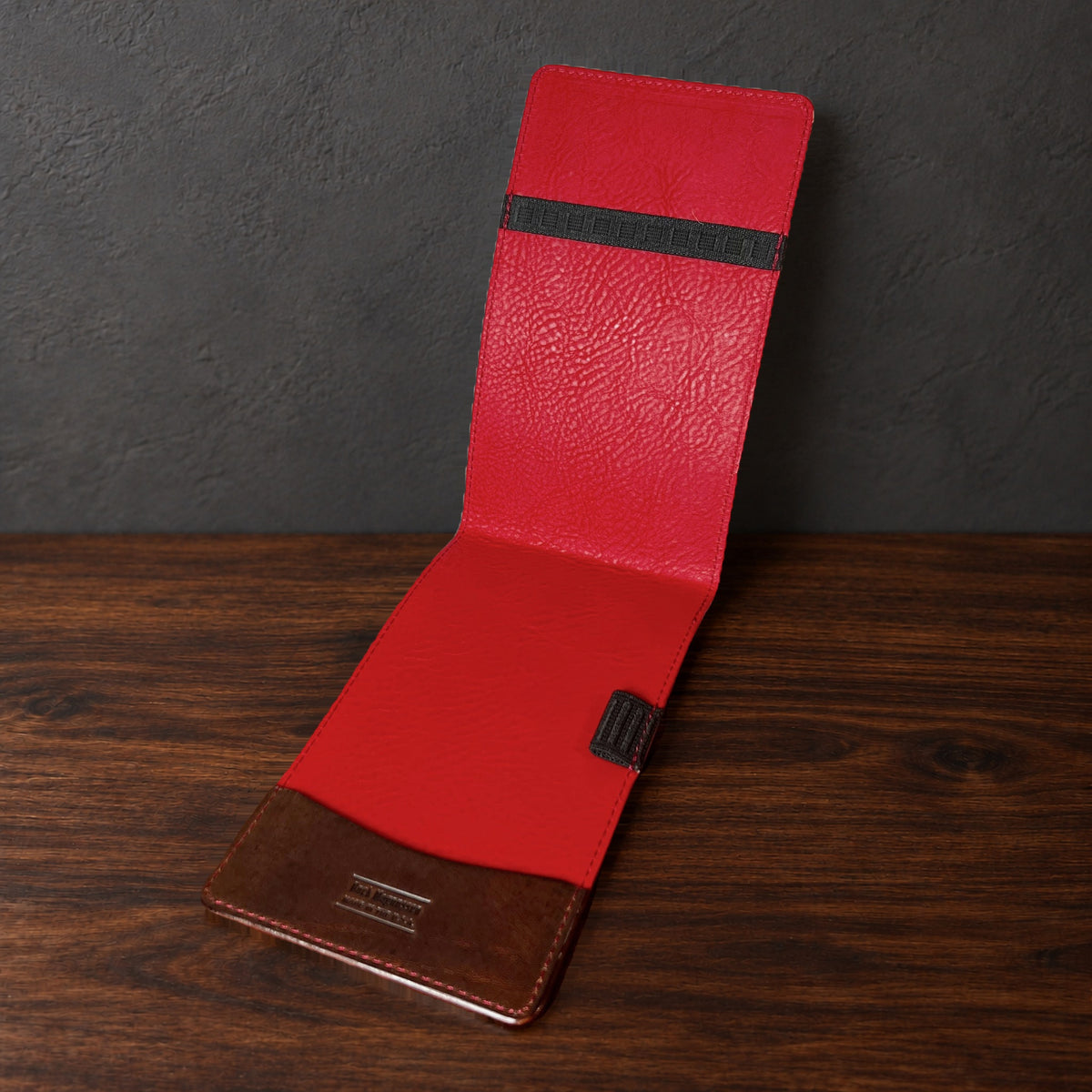 Augusta Pro yardage book cover in Nemesis standing open, showing the red interior