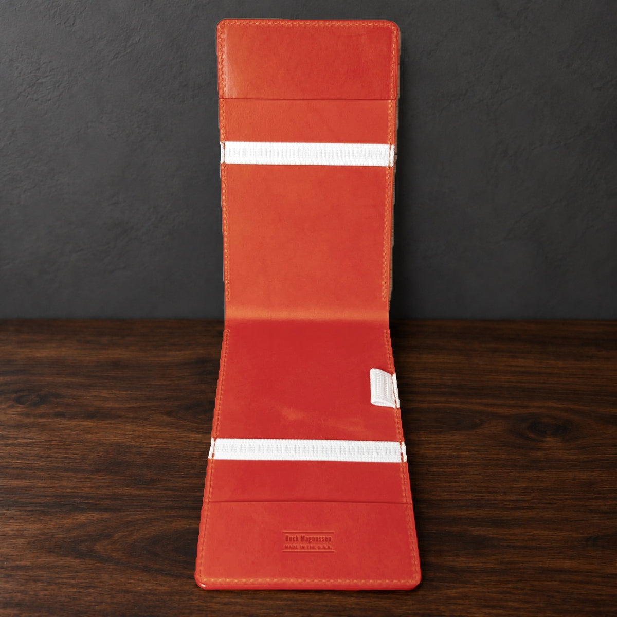 Inside the Oakmont Pro yardage book cover: orange interior, elastics at the top and bottom and a pencil loop