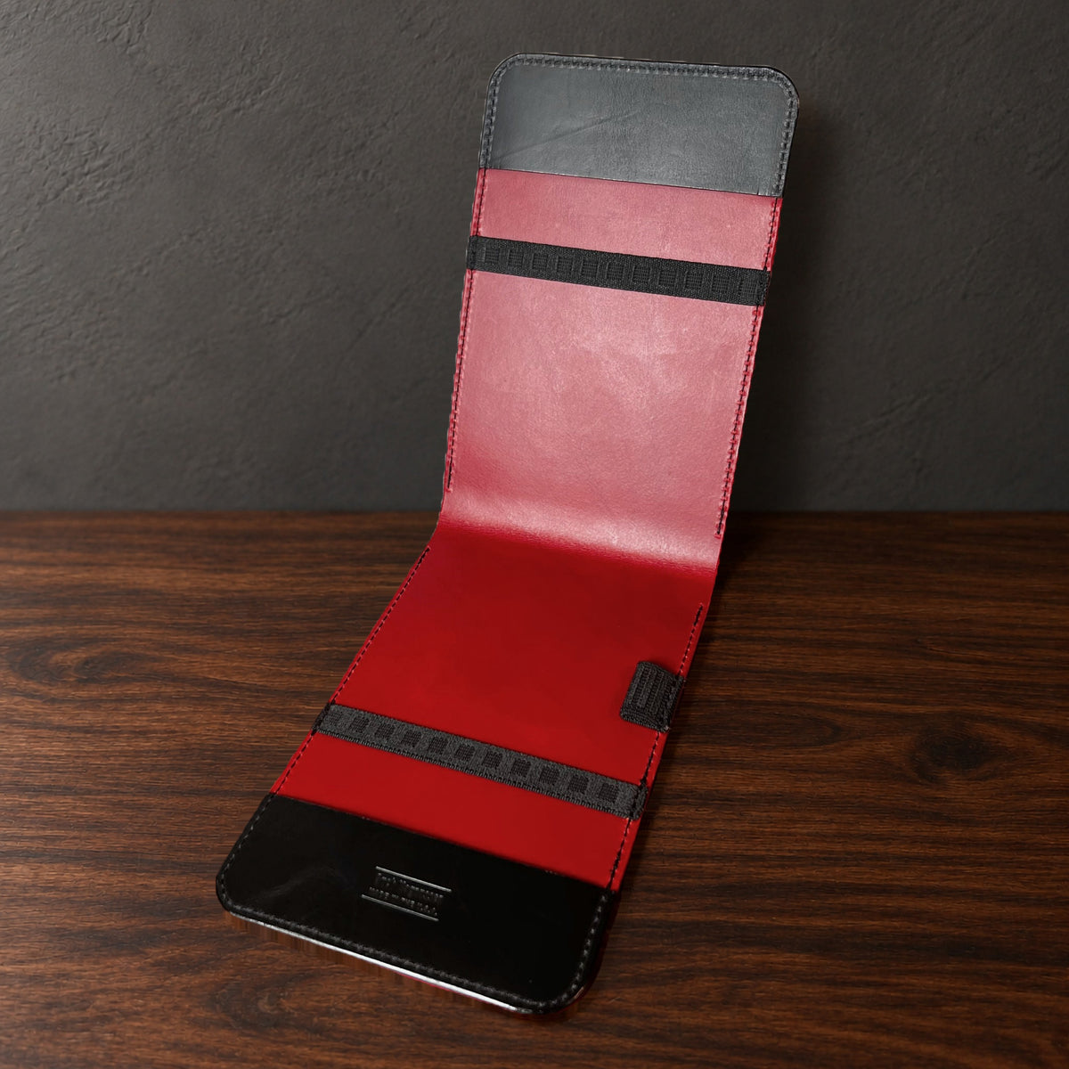 Oakmont Classic yardage book cover in Black Buttero standing open, showing the red interior