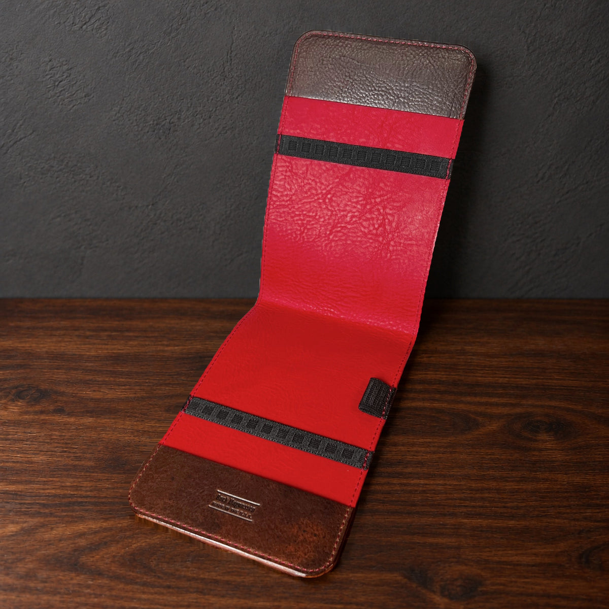 Oakmont Classic yardage book cover in Nemesis standing open, showing the red interior