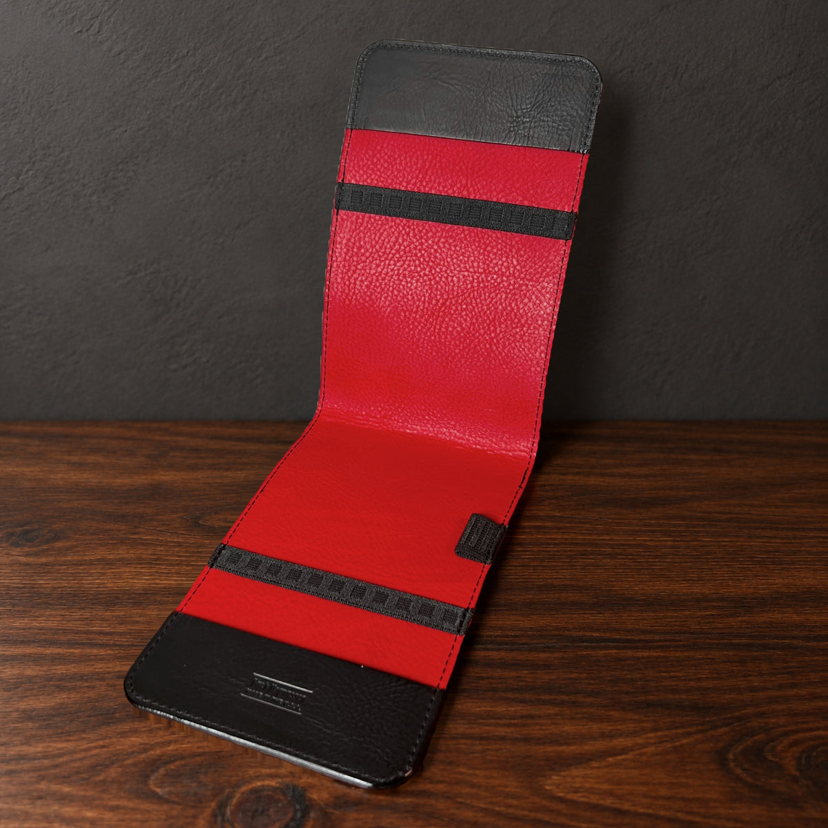Oakmont Classic yardage book cover in Black Waxy standing open, showing the red interior