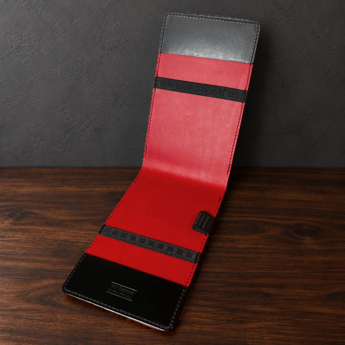 Oakmont Pro yardage book cover in Black Buttero standing open, showing the red interior