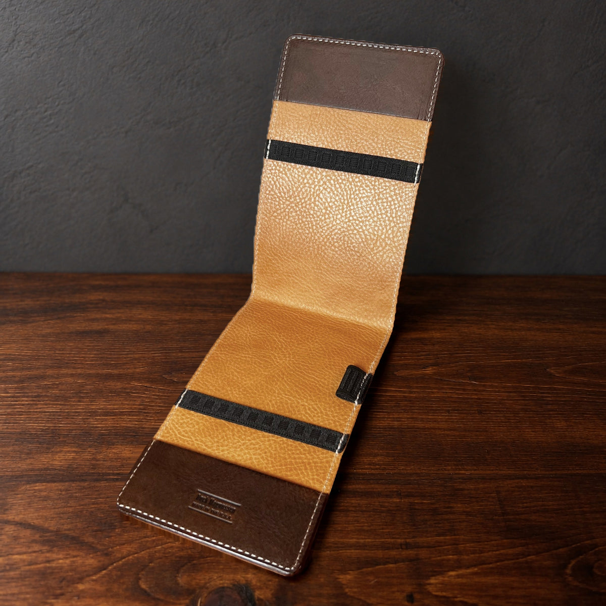 Oakmont Pro yardage book cover in Nemesis standing open, showing the natural interior
