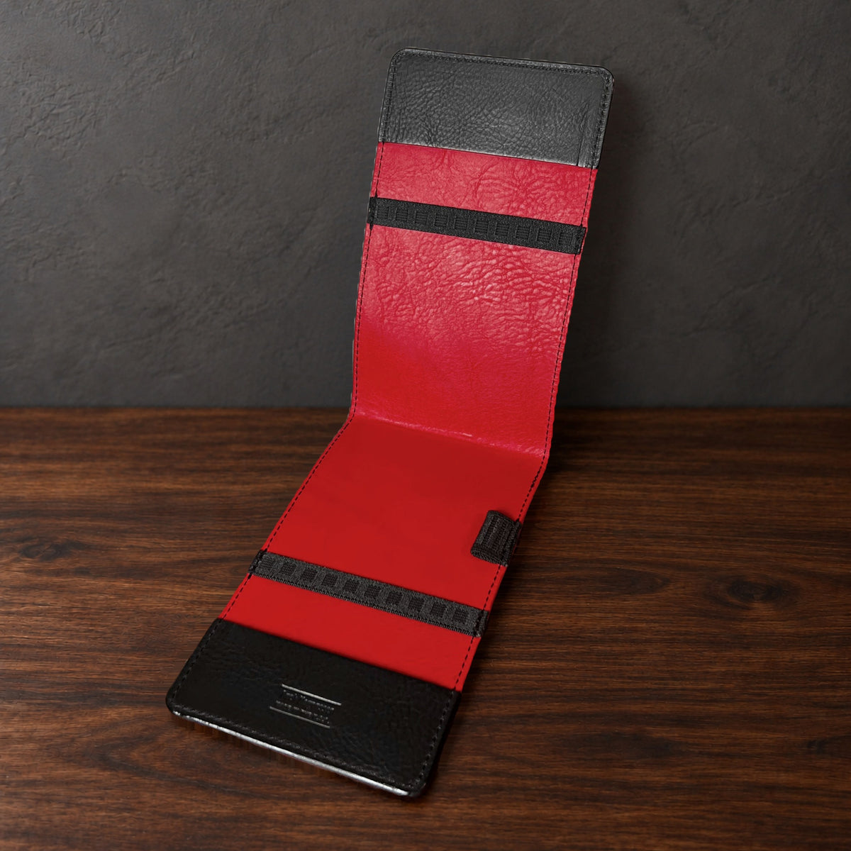 Oakmont Pro yardage book cover in Black Waxy standing open, showing the red interior